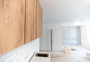 Newly installed custom kitchen cabinets and tile backsplash in La Crescenta studio.